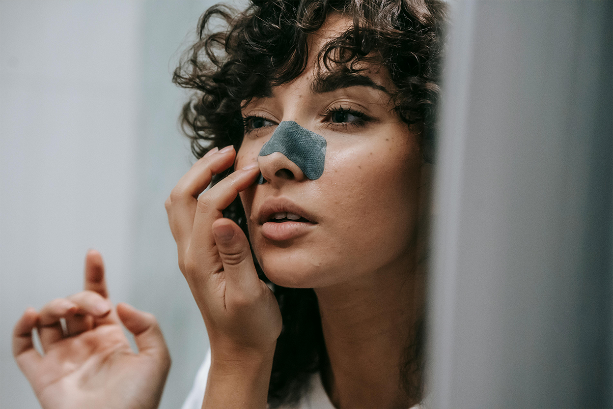 Woman applies cruelty-free mud mask on her face